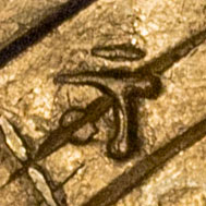 Possibly 寸 - スン - measurement, tenth of a shaku, a little, small